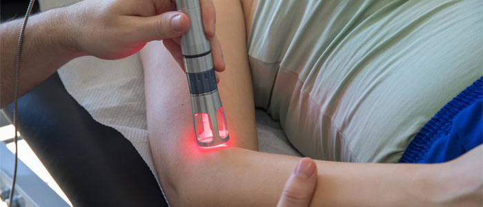 Person getting laser therapy on their elbow